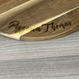 Dieses personalisierte runde Servierbrett aus FSC-zertifiziertem Akazienholz ist ein perfektes Geschenk für Familie oder Freunde. Mit individueller Gravur wie „Finger weg von [Name]’s Pizza“ wird es zu einem einzigartigen Küchenhighlight. Ideal zum Servieren von Pizza, Tapas oder Käseplatten bei gemütlichen Abenden. Das langlebige, antibakterielle Holz und der praktische Griff sorgen für Funktionalität und Stil. Ein dekoratives und praktisches Präsent für jeden Anlass.
