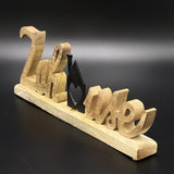Schriftzug Zuhause aus Mangoholz mit Häuschen aus schwarzem Metall, personalisierbar