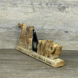 Schriftzug Zuhause aus Mangoholz mit Häuschen aus schwarzem Metall, personalisierbar